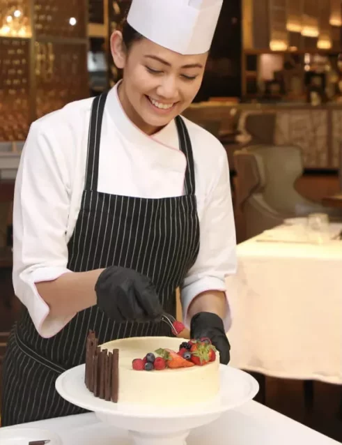 A chef preparing a delicious fruit cake during a cooking class in Dubai