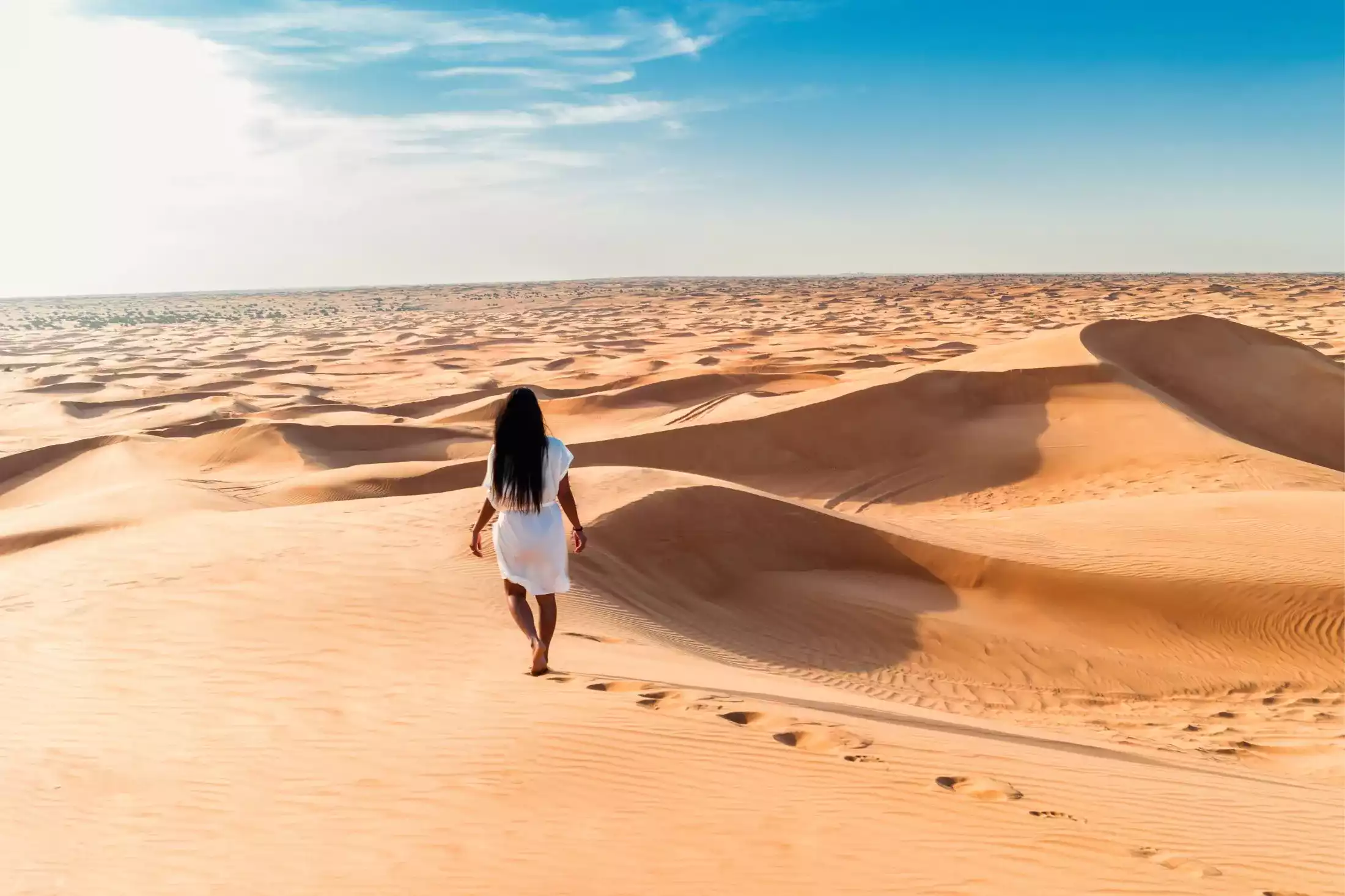Woman walking through a desert