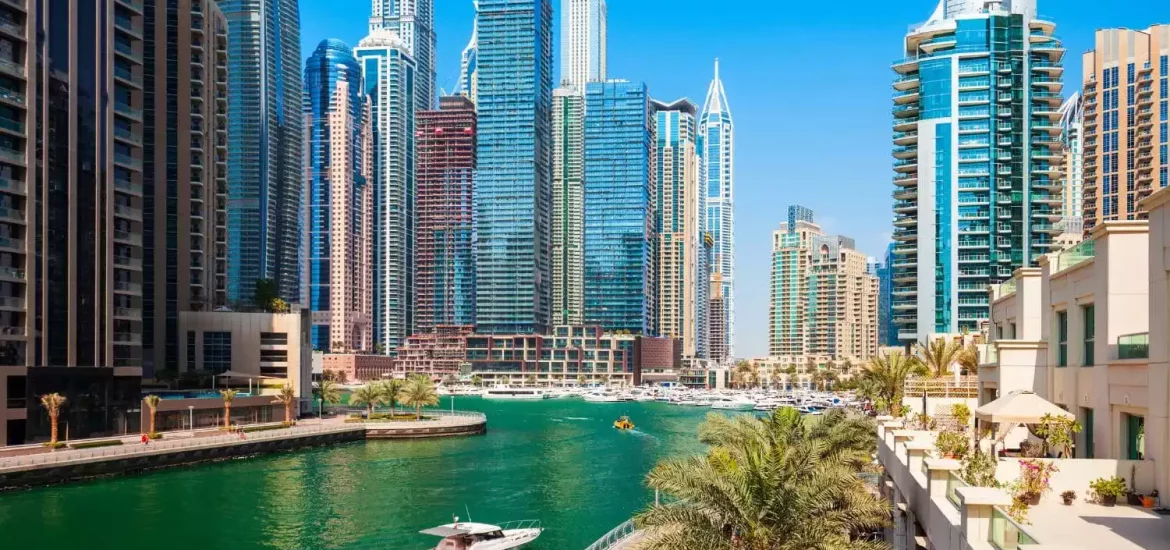 Dubai Water Canal during a sunny day with the skyline in the background