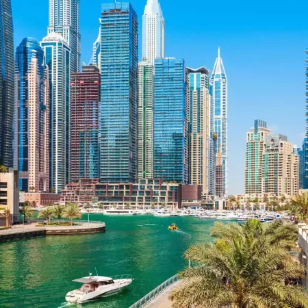 Dubai Water Canal during a sunny day with the skyline in the background