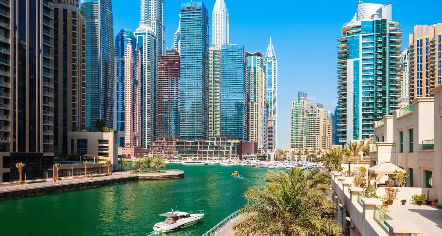 Dubai Water Canal during a sunny day with the skyline in the background
