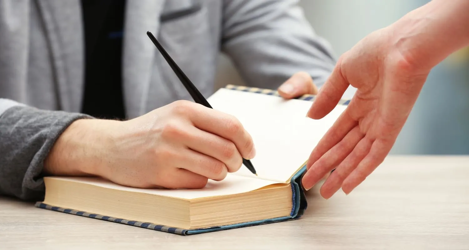 An author doing book signings for fans.