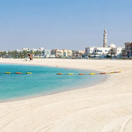 Mercato Beach with turquoise water, white sand and low-rise Dubai coastline