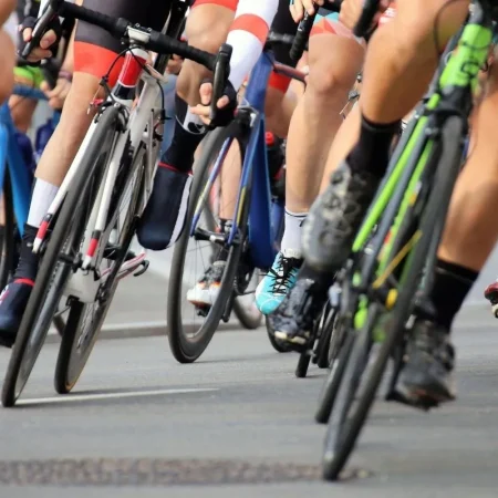 Road cyclists riding in a tight pack, the kind of mass ride Dubai Fitness Challenge 2026 will bring to the city