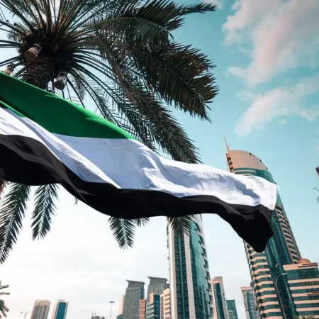 UAE flag waving against Dubai skyscrapers ahead of Eid Al Etihad 2026