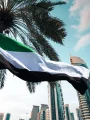 UAE flag waving against Dubai skyscrapers ahead of Eid Al Etihad 2026